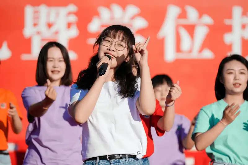 Students performing on stage during graduation ceremony celebration